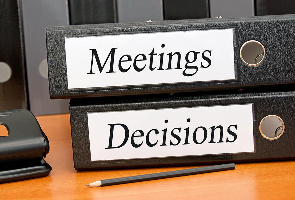 meeting graphic with binders labeled meetings and decisions